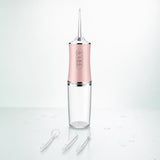 Irrigador dental portátil Oravia rosa con sus 4 boquillas: una puesta y tres de recambio