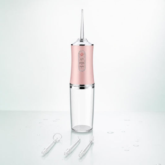 Irrigador dental portátil Oravia rosa con sus 4 boquillas: una puesta y tres de recambio